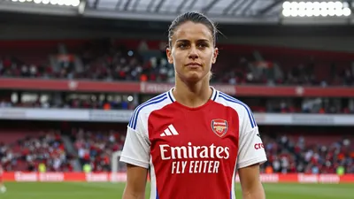A 27-year-old Swiss midfielder in an Arsenal Women kit, with a confident expression, standing in front of a blurred...