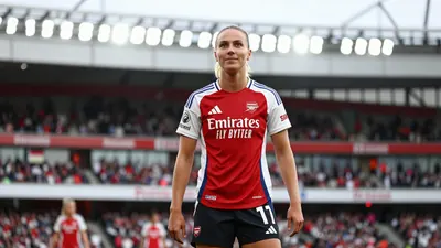 A photorealistic image of an anonymous Arsenal Women player in a red jersey, with a white kit and black shorts, standing...