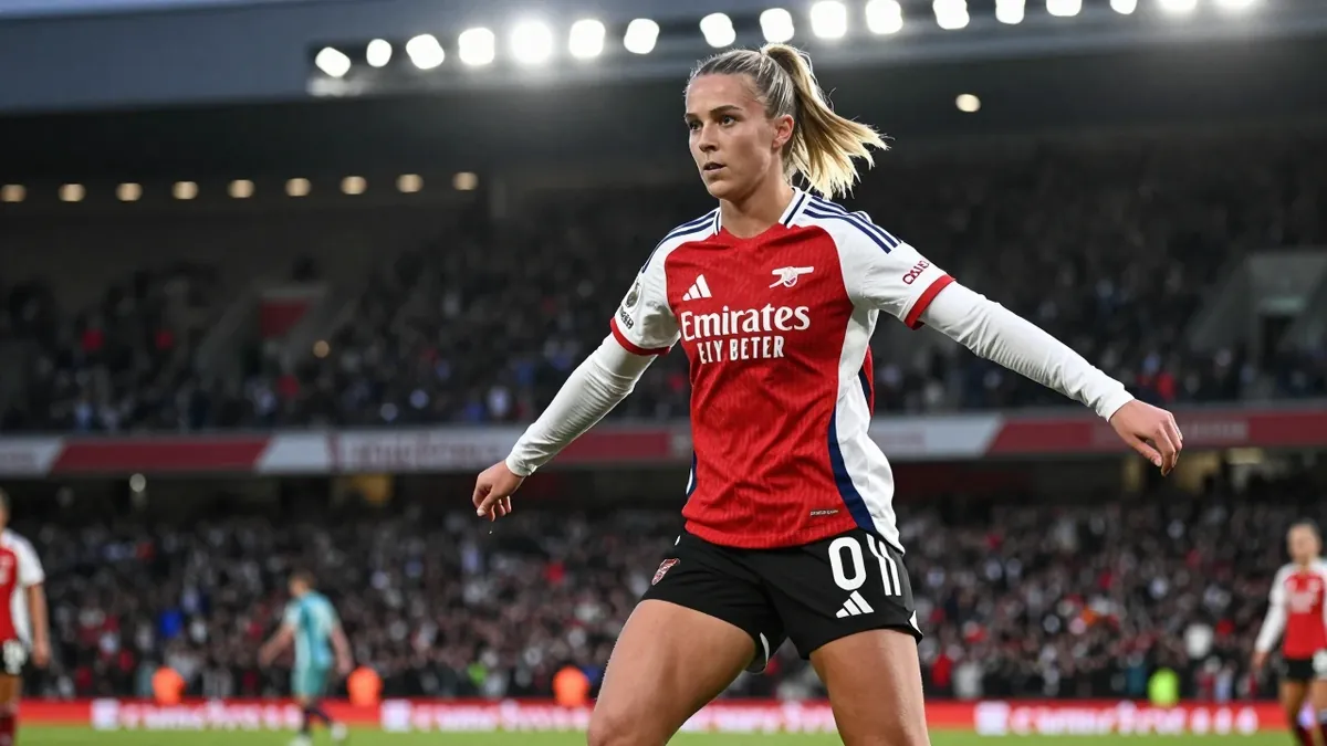 19-year-old Arsenal Women midfielder, lean and energetic, in a red and white striped jersey and black shorts, her legs...