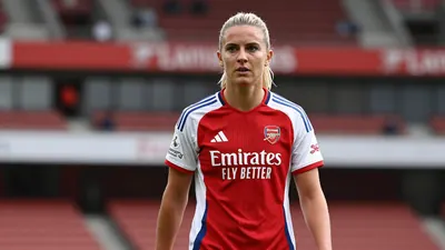 A determined 25-year-old Arsenal Women midfielder, with a strong athletic build, wearing the red and white home kit with...