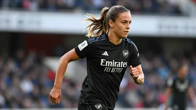 19-year-old Arsenal Women winger, a slender build with energetic movement, is captured in a tight action crop, waist-up...