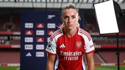 A determined 25-year-old Arsenal Women midfielder, wearing the red and white home kit with the Arsenal Women crest on the...