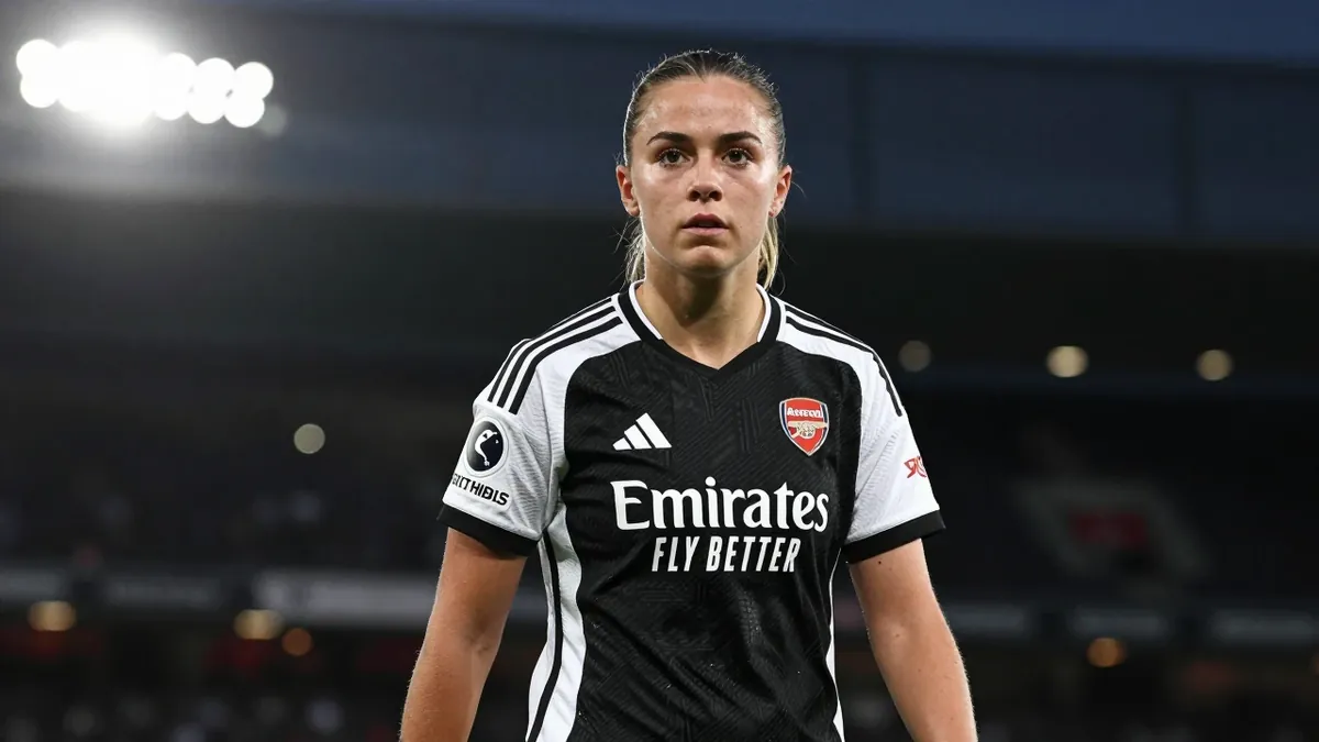 19-year-old winger, build: slim and agile, wearing Arsenal Women's black and white stripes, focused on determined eyes